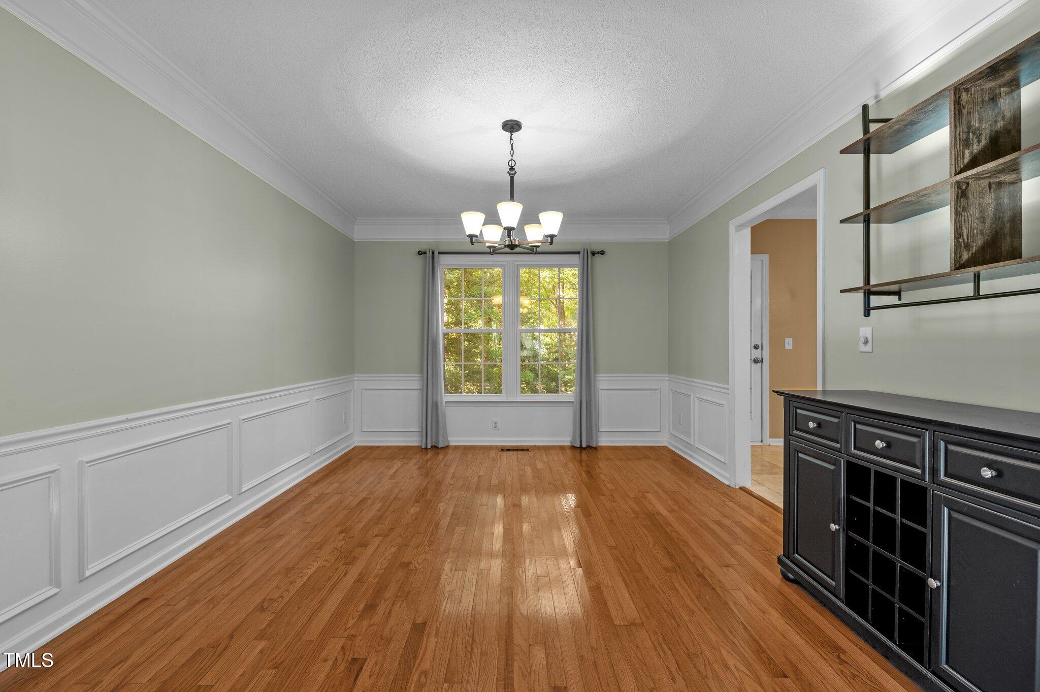 6209 Brielson Place Raleigh, NC 27616 - Photo 11 of 41 a furnished livingroom with windows and hardwood floor