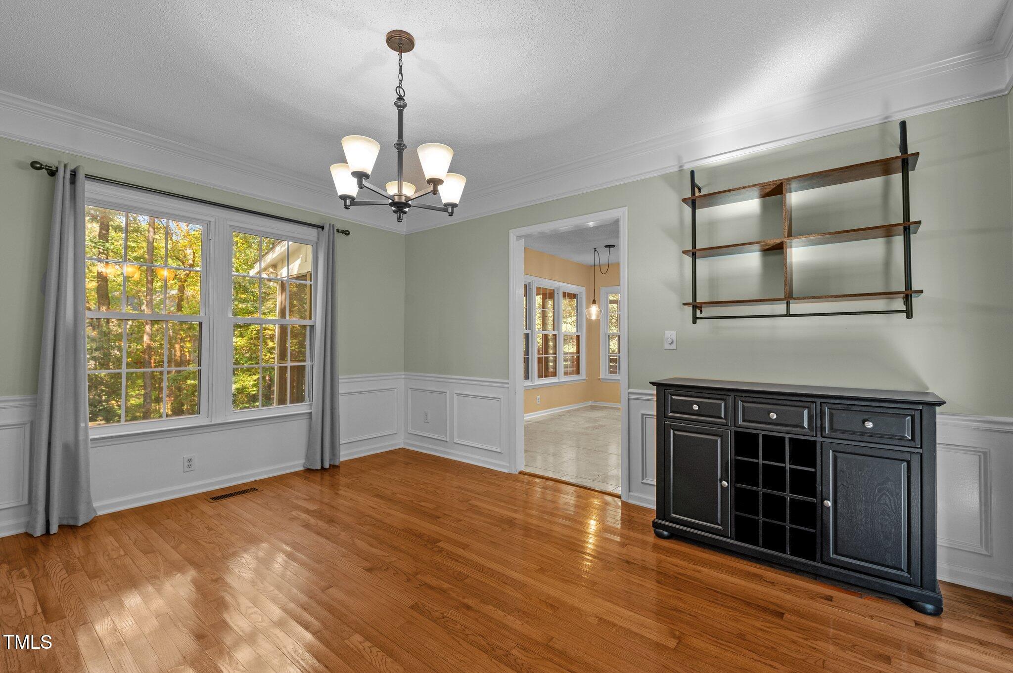 6209 Brielson Place Raleigh, NC 27616 - Photo 12 of 41 a view of an empty room with wooden floor and a window