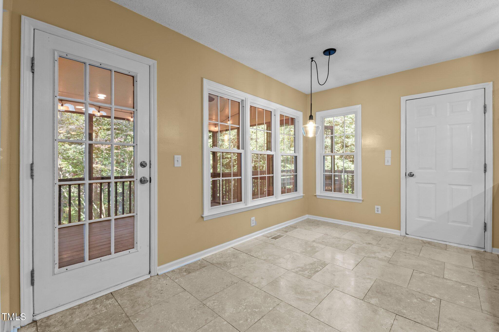 6209 Brielson Place Raleigh, NC 27616 - Photo 13 of 41 a view of an empty room with glass door and windows