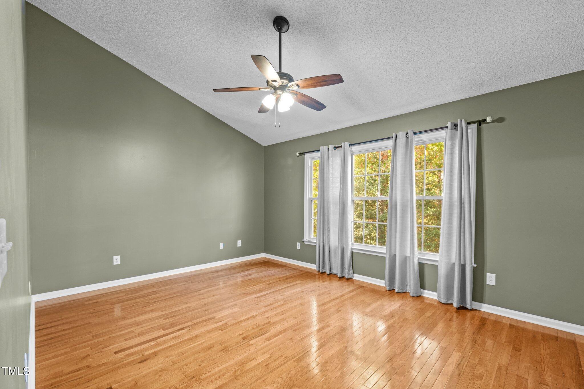 6209 Brielson Place Raleigh, NC 27616 - Photo 19 of 41 a view of a room with a ceiling fan and a window