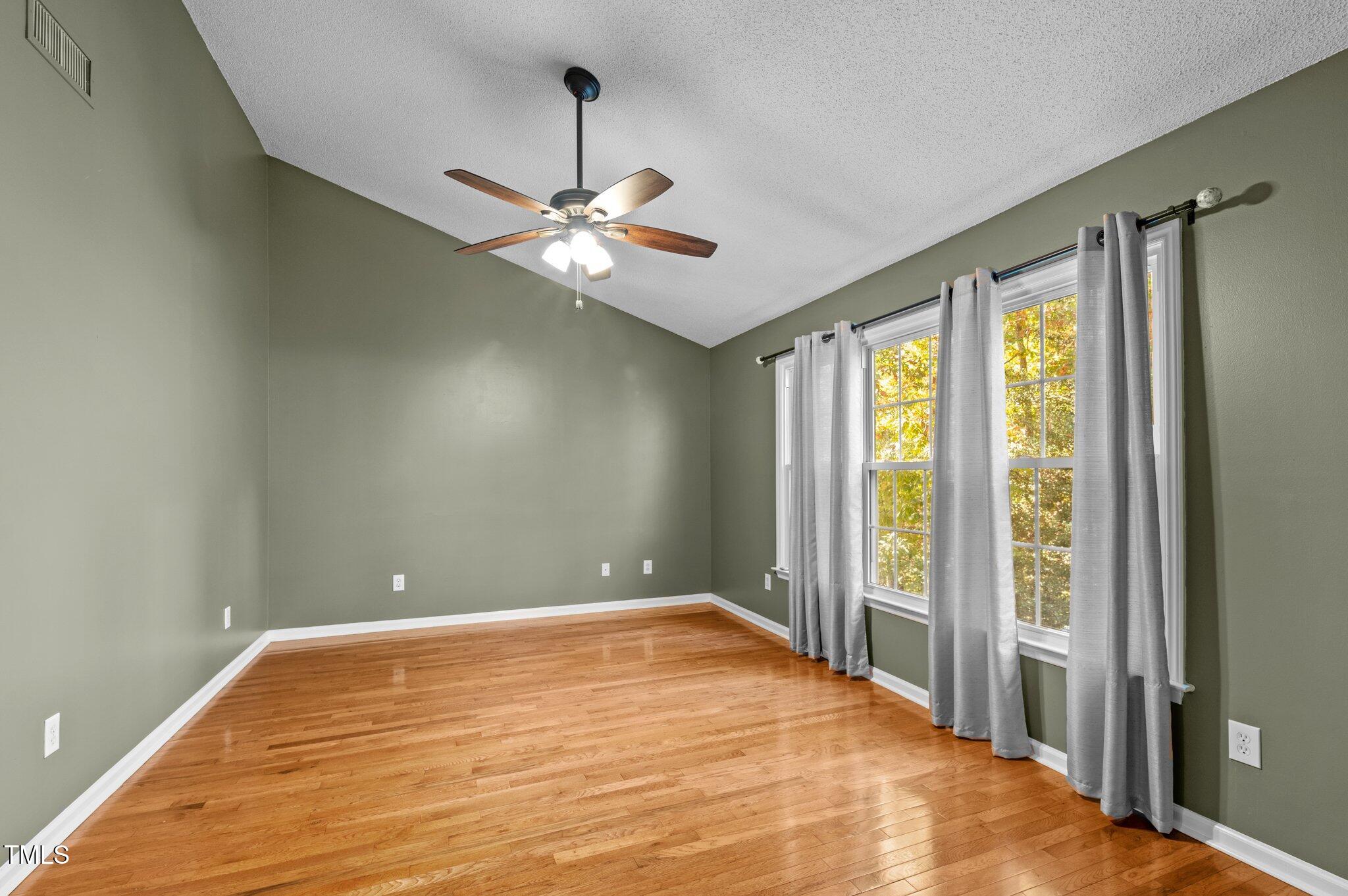 6209 Brielson Place Raleigh, NC 27616 - Photo 20 of 41 a view of empty room with wooden floor and fan