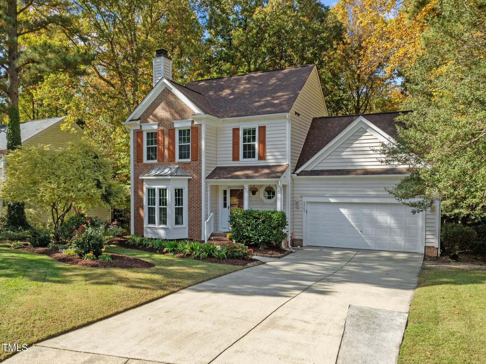 6209 Brielson Place Raleigh, NC 27616 - Photo 2 of 41 a front view of a house with a yard and trees