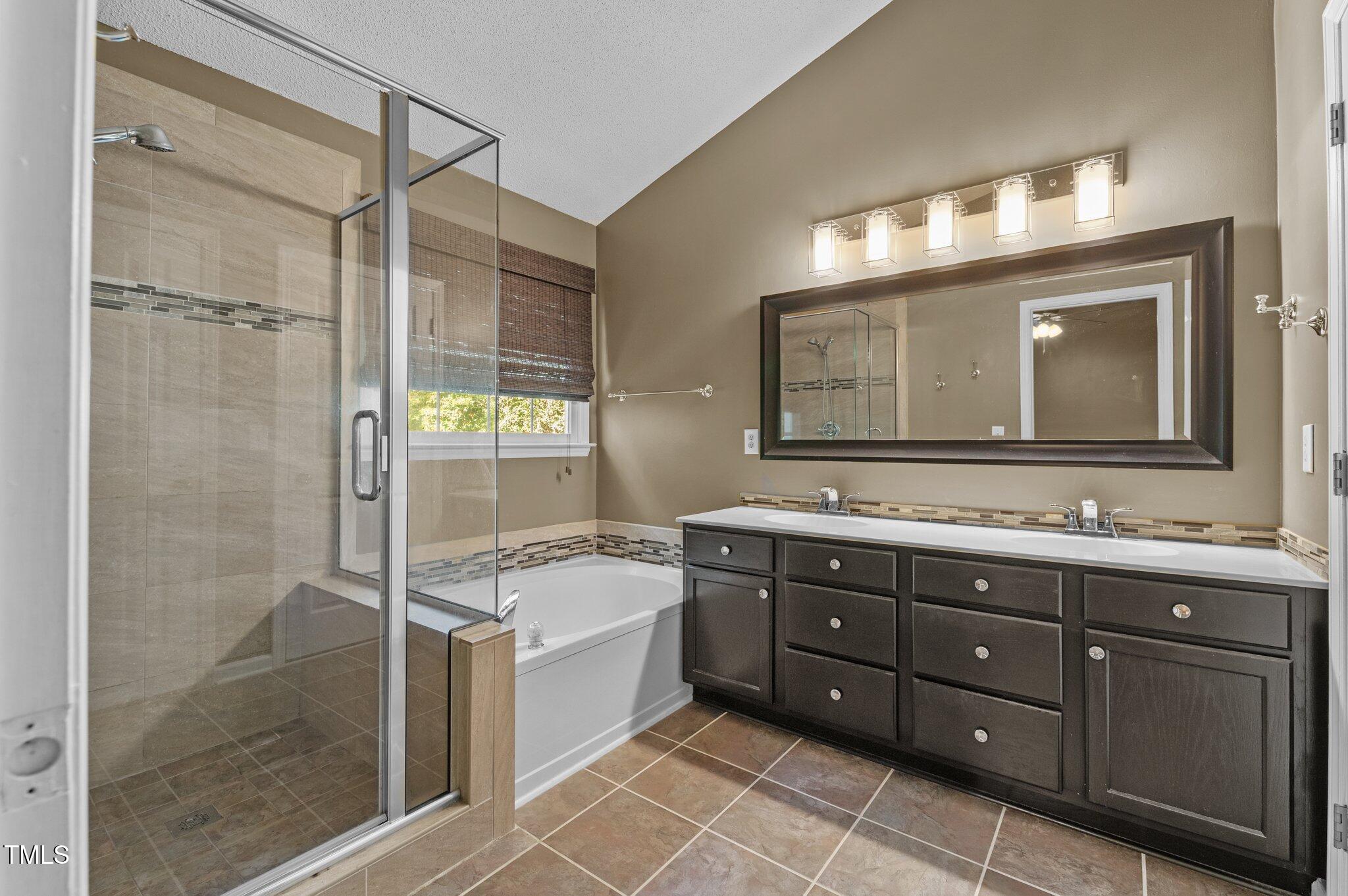 6209 Brielson Place Raleigh, NC 27616 - Photo 21 of 41 a bathroom with a tub sink and mirror