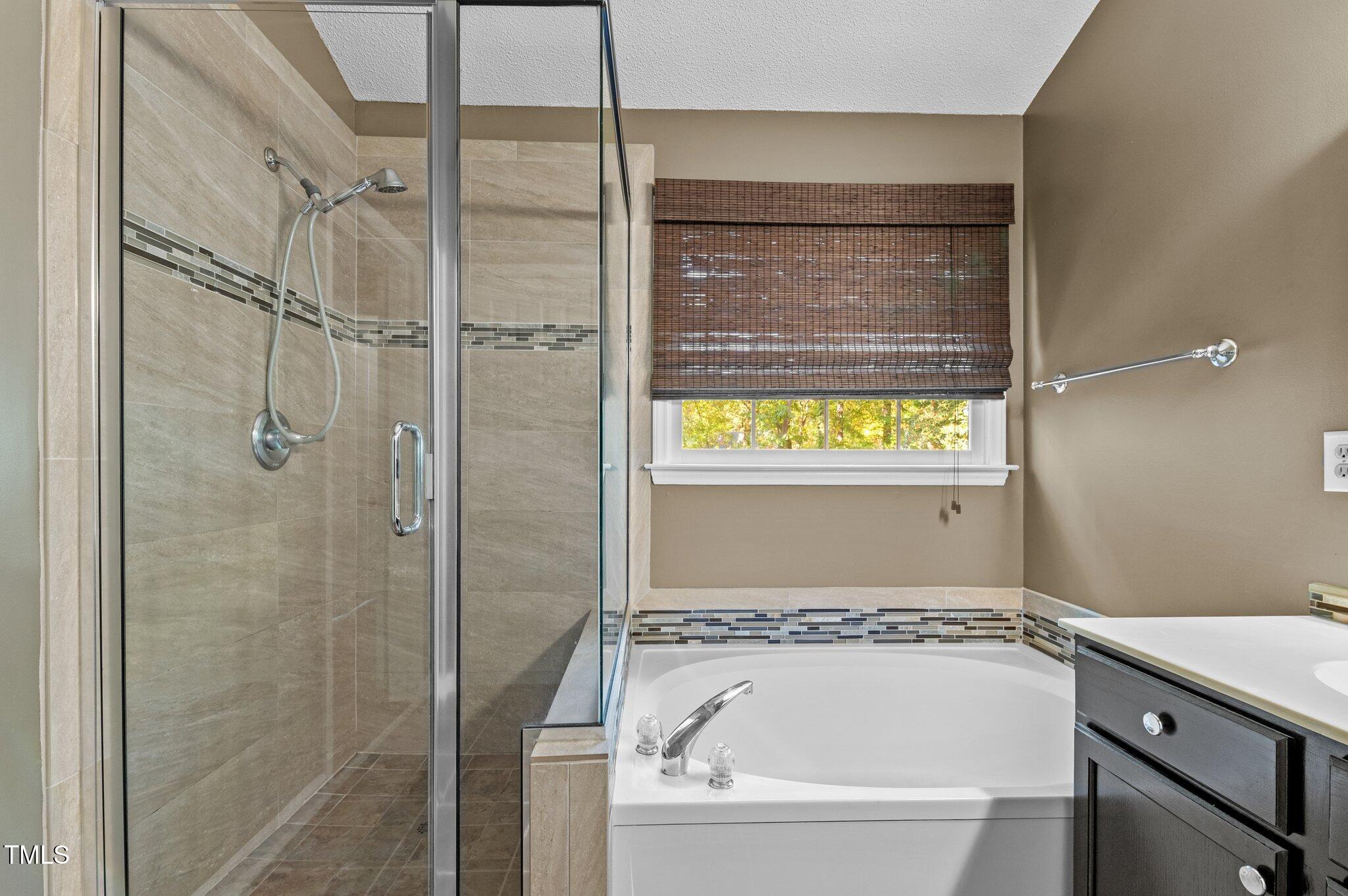 6209 Brielson Place Raleigh, NC 27616 - Photo 22 of 41 a bathroom with a bathtub and shower