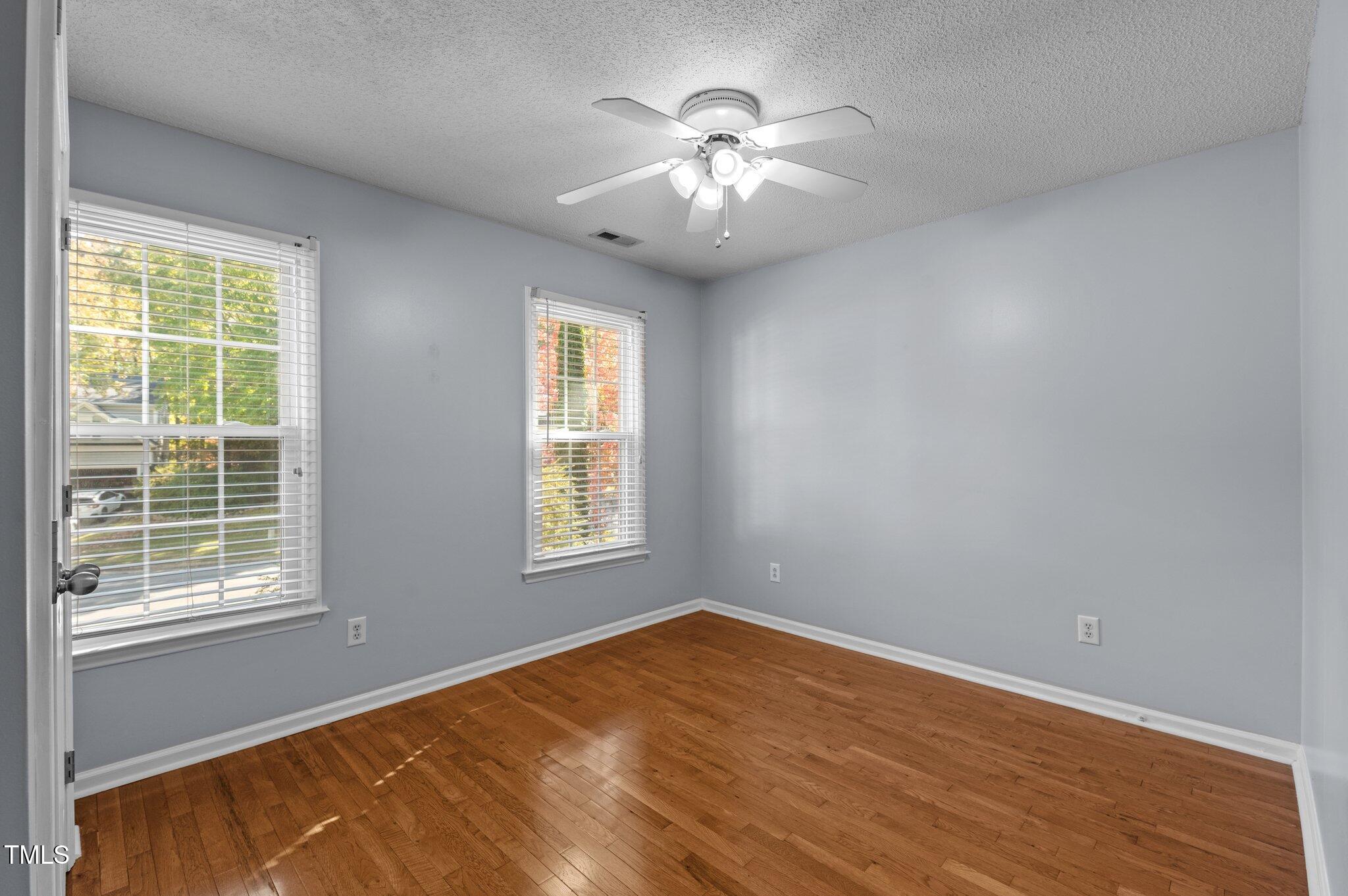 6209 Brielson Place Raleigh, NC 27616 - Photo 26 of 41 a view of an empty room with wooden floor and a window