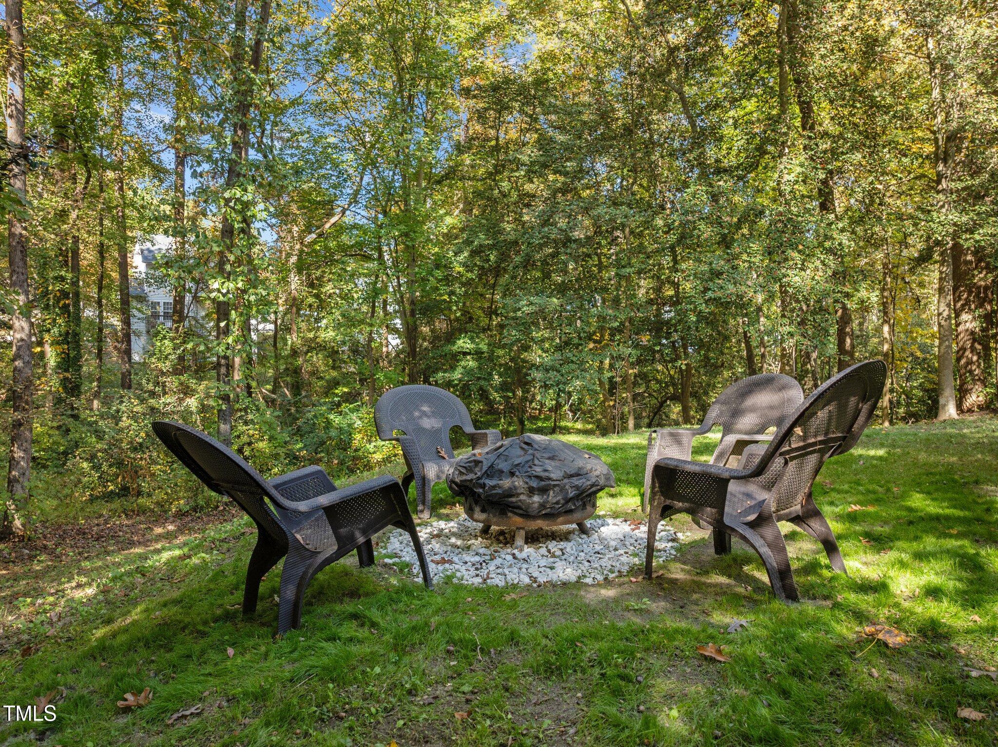 6209 Brielson Place Raleigh, NC 27616 - Photo 37 of 41 a backyard of a house with table and chairs
