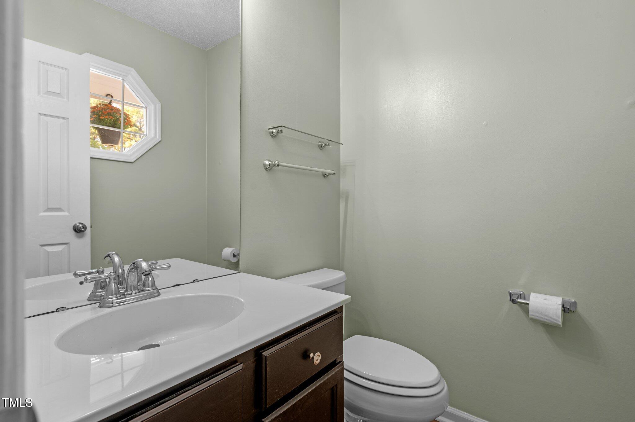 6209 Brielson Place Raleigh, NC 27616 - Photo 6 of 41 a bathroom with a sink toilet and vanity