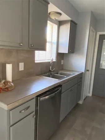 a kitchen with sink cabinets and window