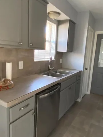 a kitchen with sink cabinets and window