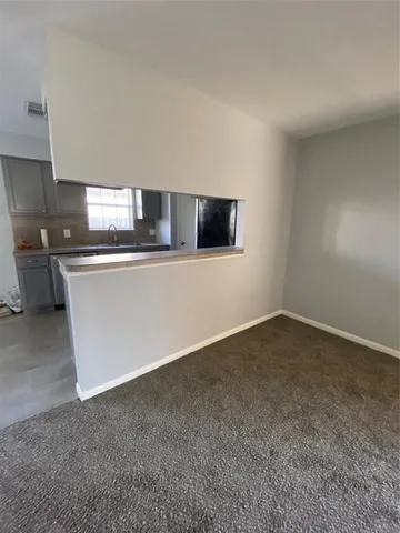 a kitchen with stainless steel appliances a sink a stove top oven a counter space and cabinets