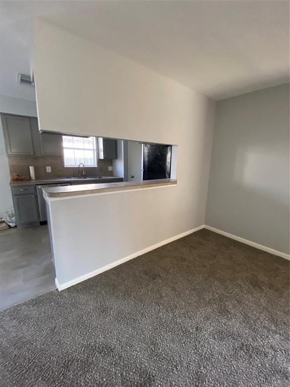 4714 Geraldine Street Pasadena, TX 77586 - Photo 5 of 11 a kitchen with stainless steel appliances a sink a stove top oven a counter space and cabinets