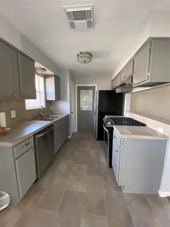 a kitchen with a stove and a sink