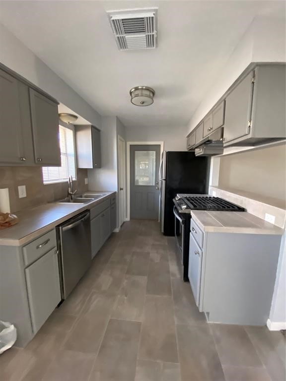 4714 Geraldine Street Pasadena, TX 77586 - Photo 6 of 11 a kitchen with a stove and a sink
