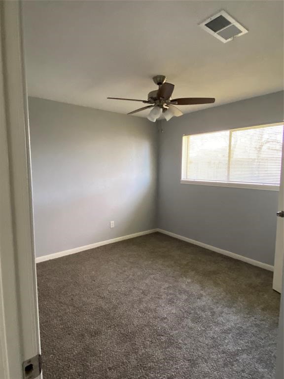 4714 Geraldine Street Pasadena, TX 77586 - Photo 8 of 11 an empty room with windows and fan