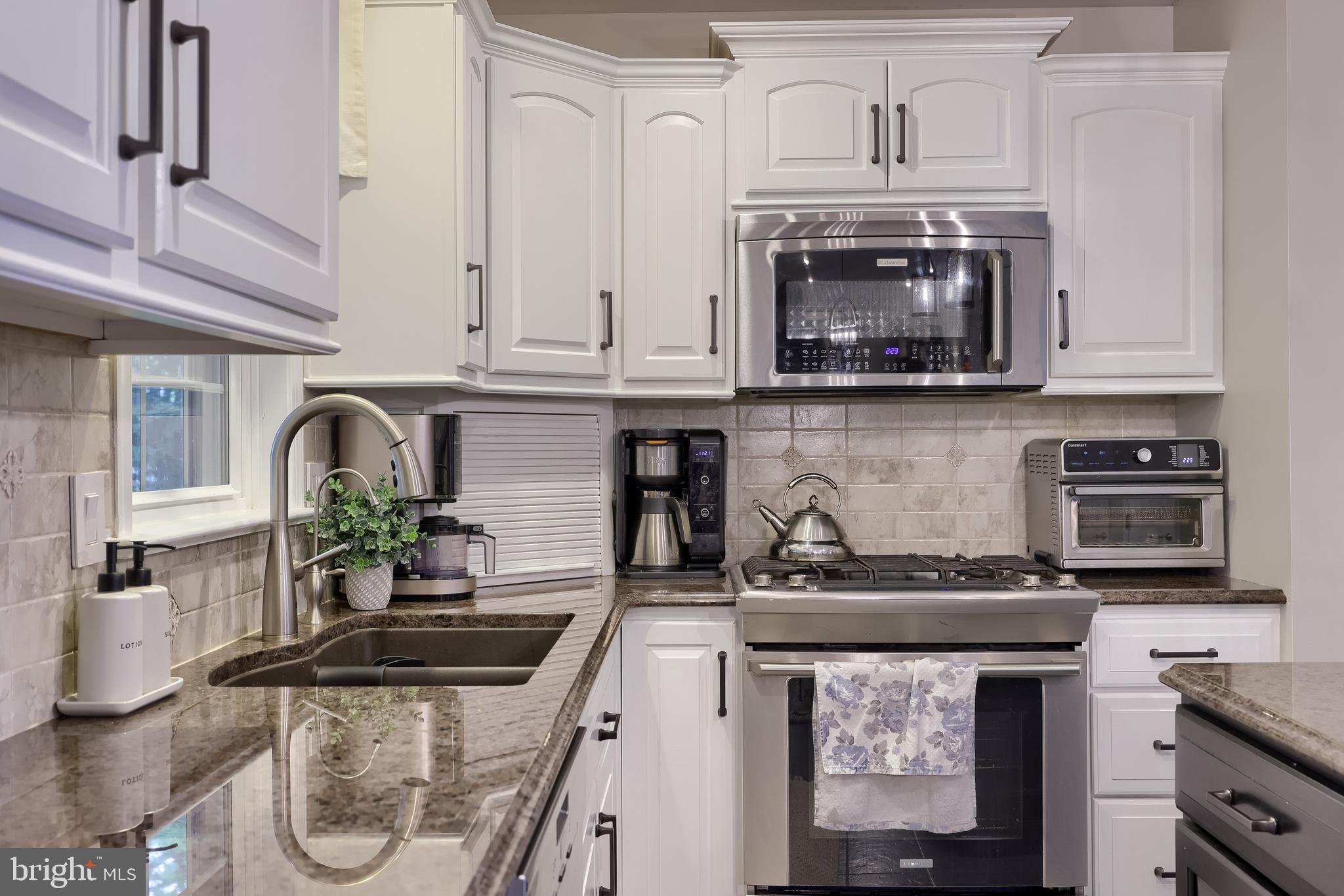 315 Royal Hunt Way Lititz, PA 17543 - Photo 18 of 67 a kitchen with stainless steel appliances granite countertop a stove a sink and a microwave