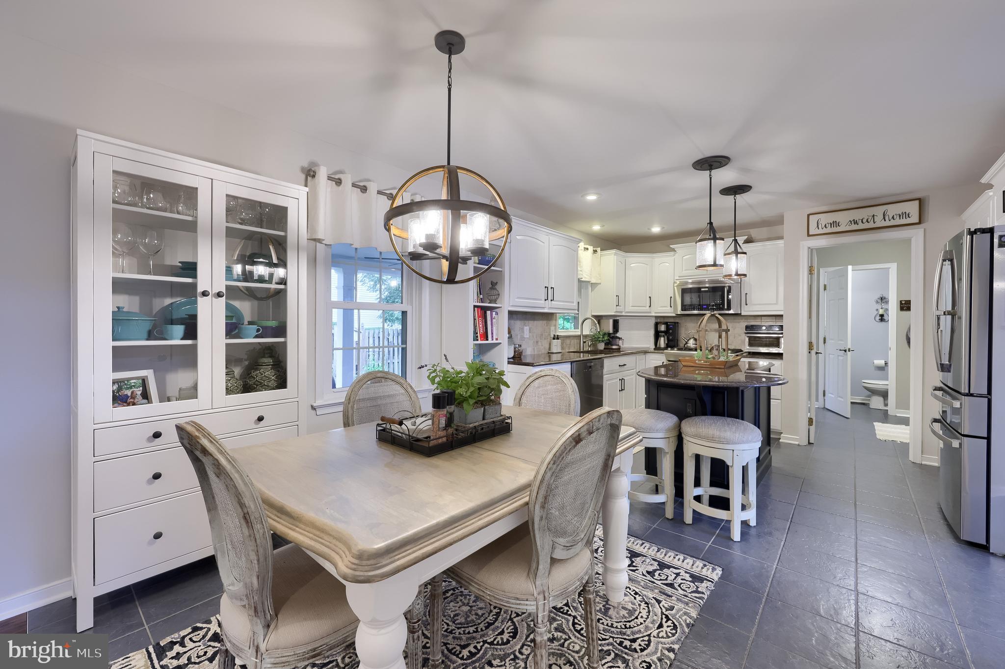315 Royal Hunt Way Lititz, PA 17543 - Photo 22 of 67 a kitchen with stainless steel appliances a dining table chairs and wooden floor