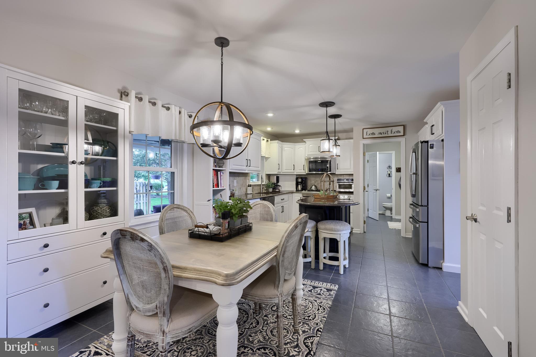 315 Royal Hunt Way Lititz, PA 17543 - Photo 23 of 67 a kitchen with stainless steel appliances kitchen island granite countertop a table chairs and a chandelier