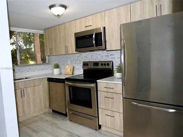 a kitchen with a stove microwave and sink