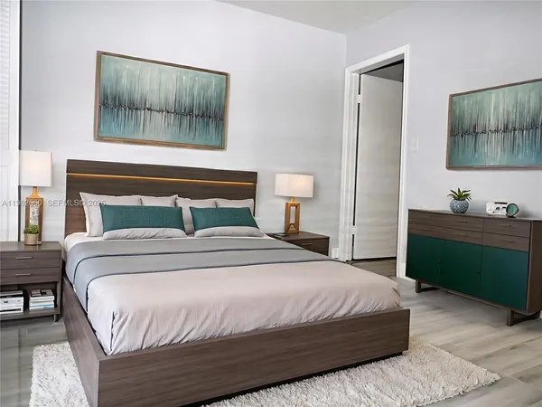 a bedroom with a bed and a mirror