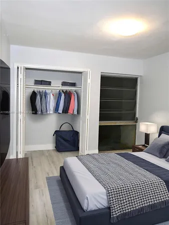 a bedroom with a bed and a couch