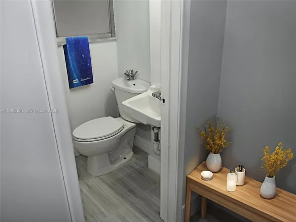 a bathroom with a toilet a sink and mirror