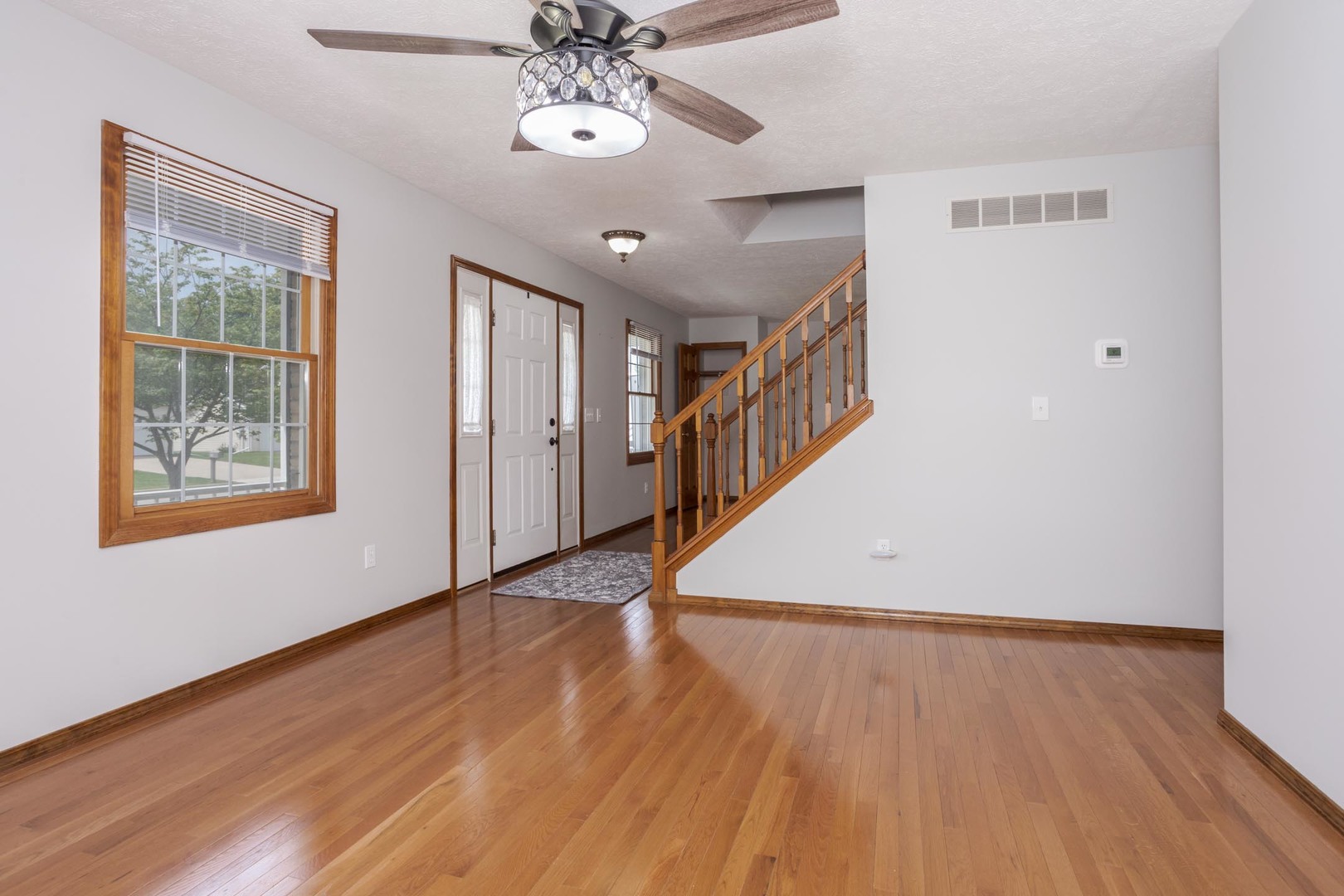 814 Landau Lane Normal, IL 61761 - Photo 29 of 58 a view of an empty room with wooden floor and a window