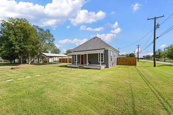 a front view of a house with a garden