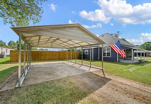 a view of a house with a yard and sitting area