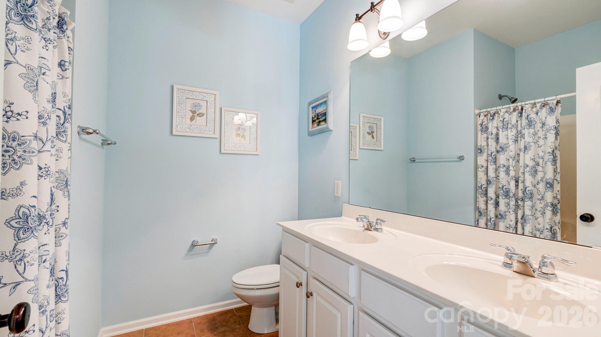 1162 Gold Rush Court Fort Mill, SC 29708 - Photo 16 of 21 a bathroom with a granite countertop sink a toilet and a mirror