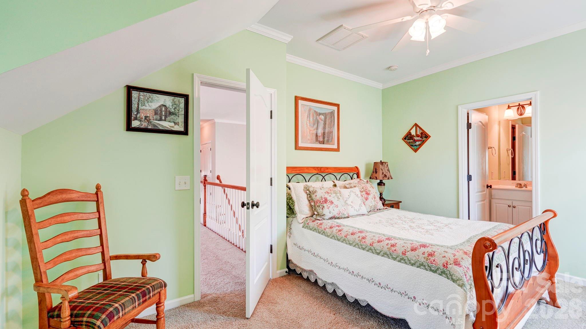 1162 Gold Rush Court Fort Mill, SC 29708 - Photo 19 of 21 a bedroom with a bed and a chandelier