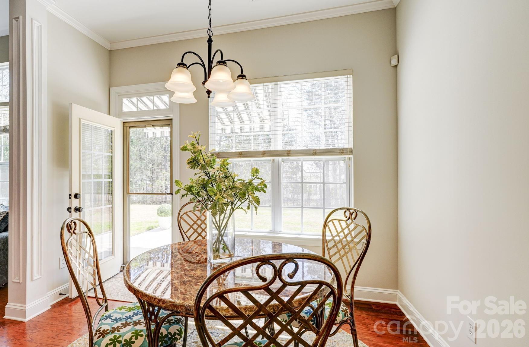 1162 Gold Rush Court Fort Mill, SC 29708 - Photo 7 of 21 a view of a dining room with furniture wooden floor and a chandelier