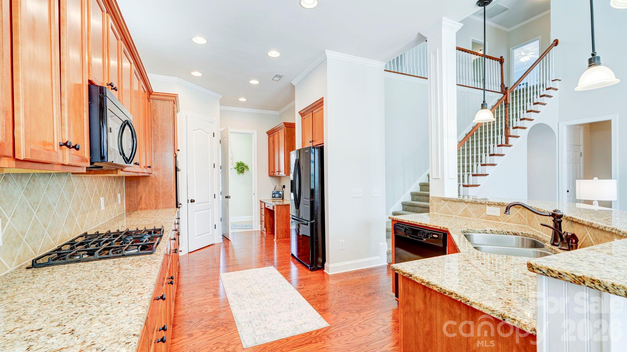 1162 Gold Rush Court Fort Mill, SC 29708 - Photo 8 of 21 a kitchen with stainless steel appliances kitchen island granite countertop a sink and a refrigerator