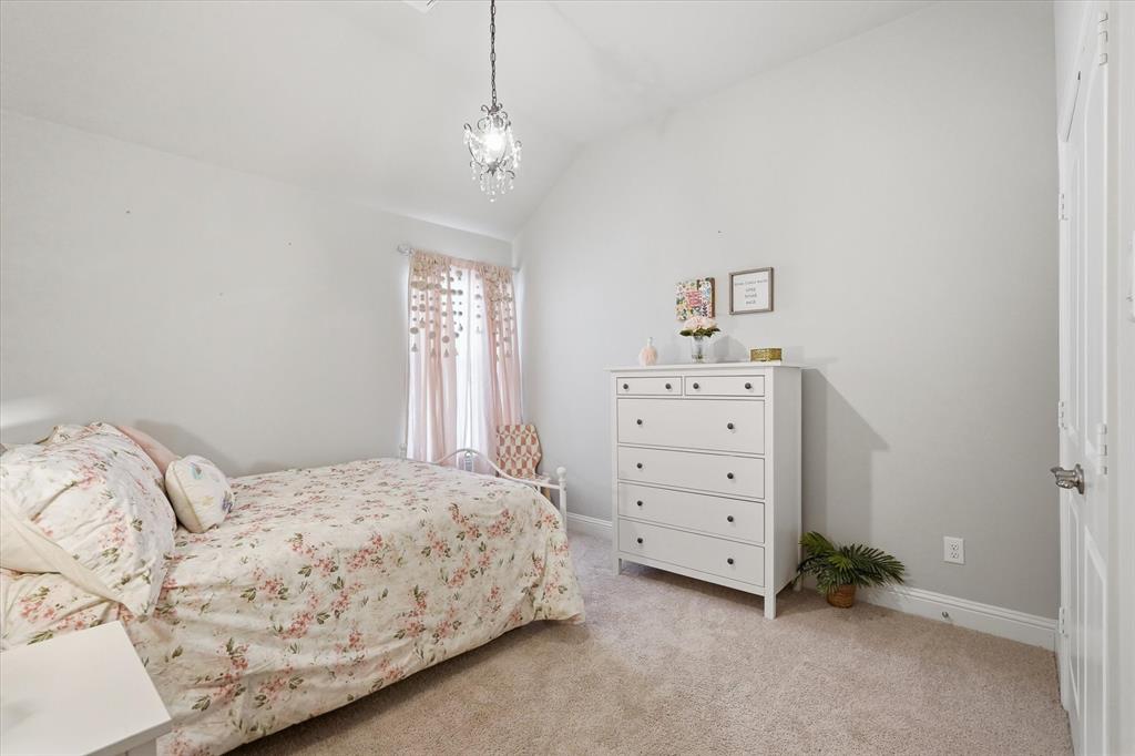813 Mildren Lane Fate, TX 75087 - Photo 15 of 32 This is one of 2 bedrooms in the middle of the home that shares a hallway to another bathroom as well as the laundry room. The chandelier in this bedroom conveys with the sale of the home.