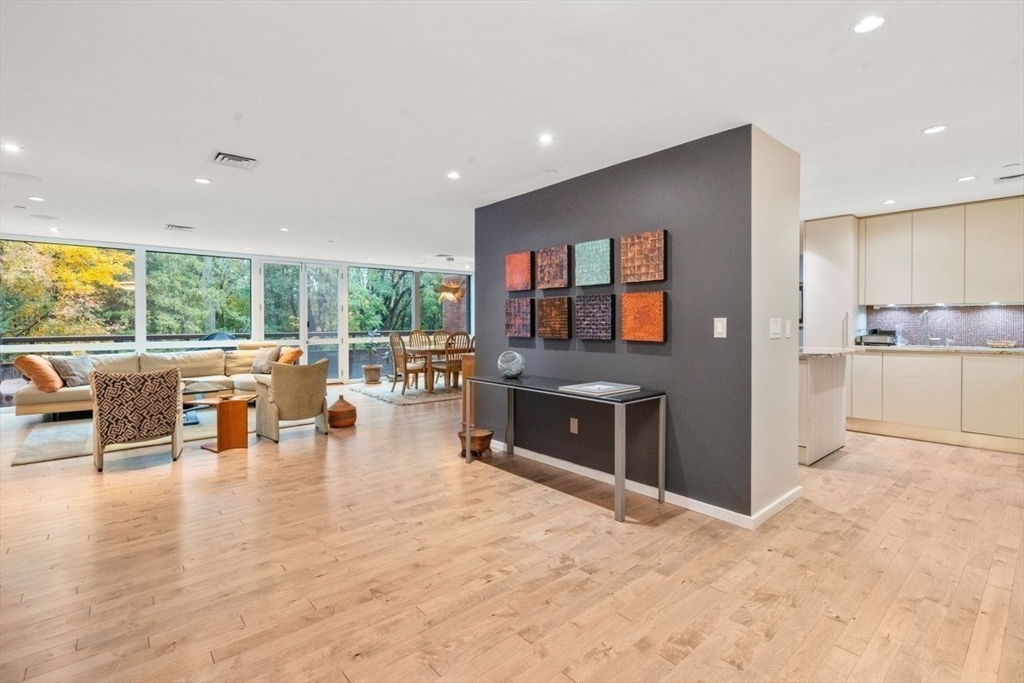 241 Perkins Street, Unit C306 Boston, MA 02130 - Photo 11 of 33 wooden floor and dining room with stainless steel appliances