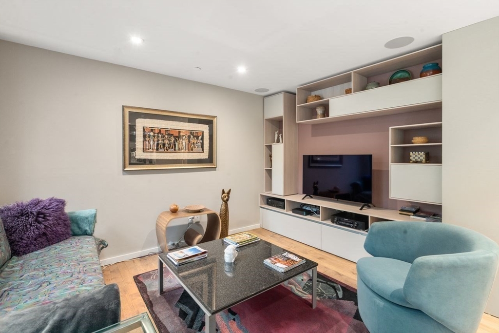 241 Perkins Street, Unit C306 Boston, MA 02130 - Photo 12 of 33 a living room with furniture and a flat screen tv