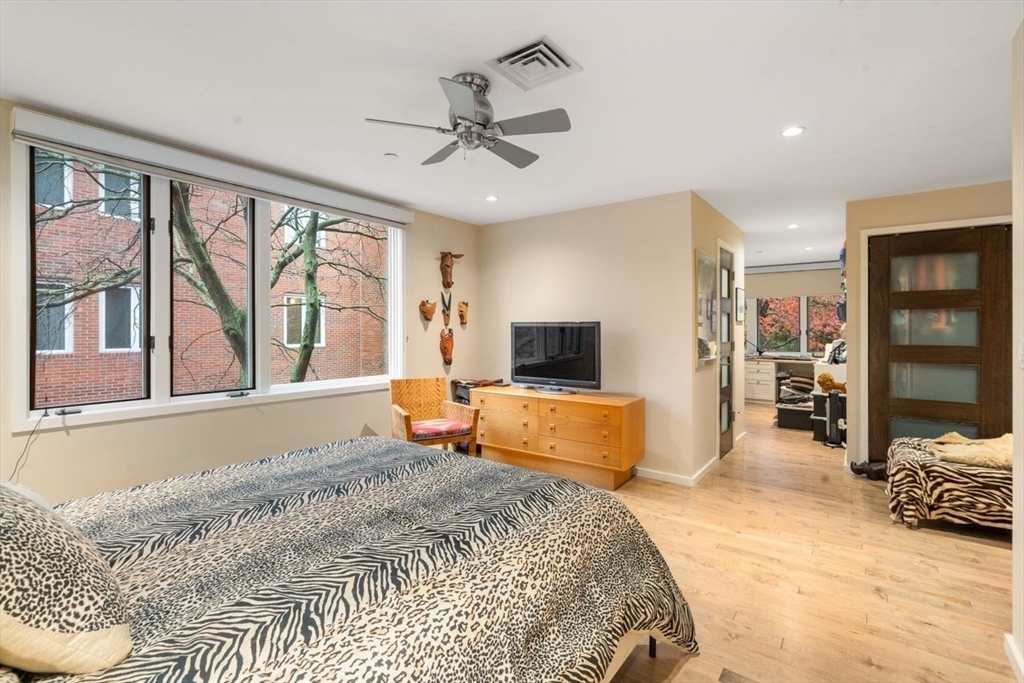 241 Perkins Street, Unit C306 Boston, MA 02130 - Photo 17 of 33 a bedroom with furniture and a flat screen tv