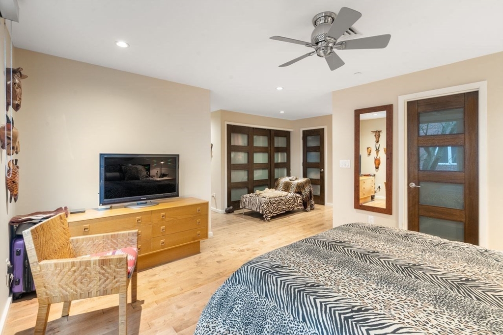 241 Perkins Street, Unit C306 Boston, MA 02130 - Photo 18 of 33 a spacious bedroom with a bed and a couch