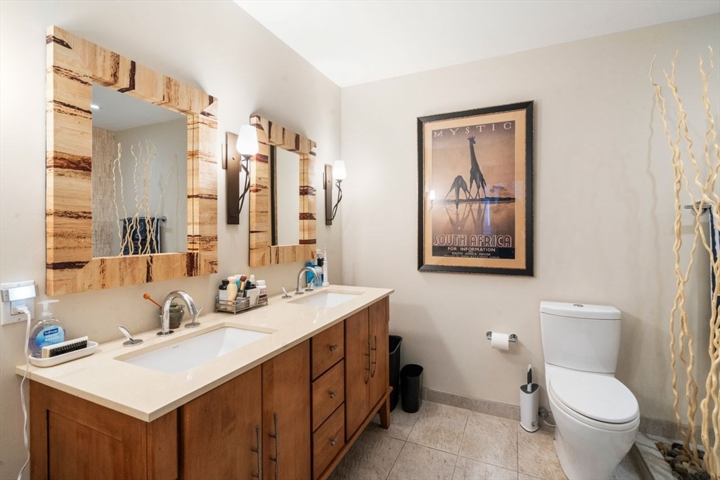 241 Perkins Street, Unit C306 Boston, MA 02130 - Photo 20 of 33 a bathroom with a toilet sink and mirror