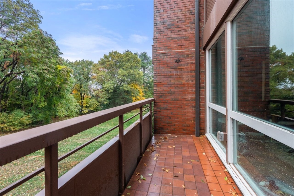 241 Perkins Street, Unit C306 Boston, MA 02130 - Photo 27 of 33 a view of balcony with wooden floor and fence