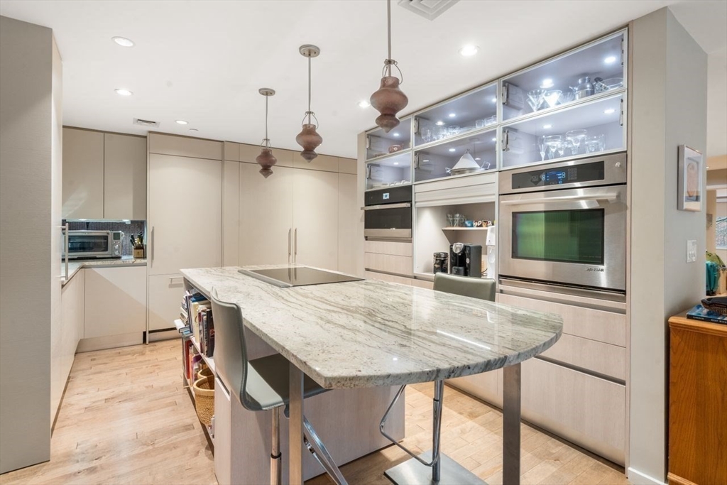 241 Perkins Street, Unit C306 Boston, MA 02130 - Photo 5 of 33 a kitchen with a table and chairs in it