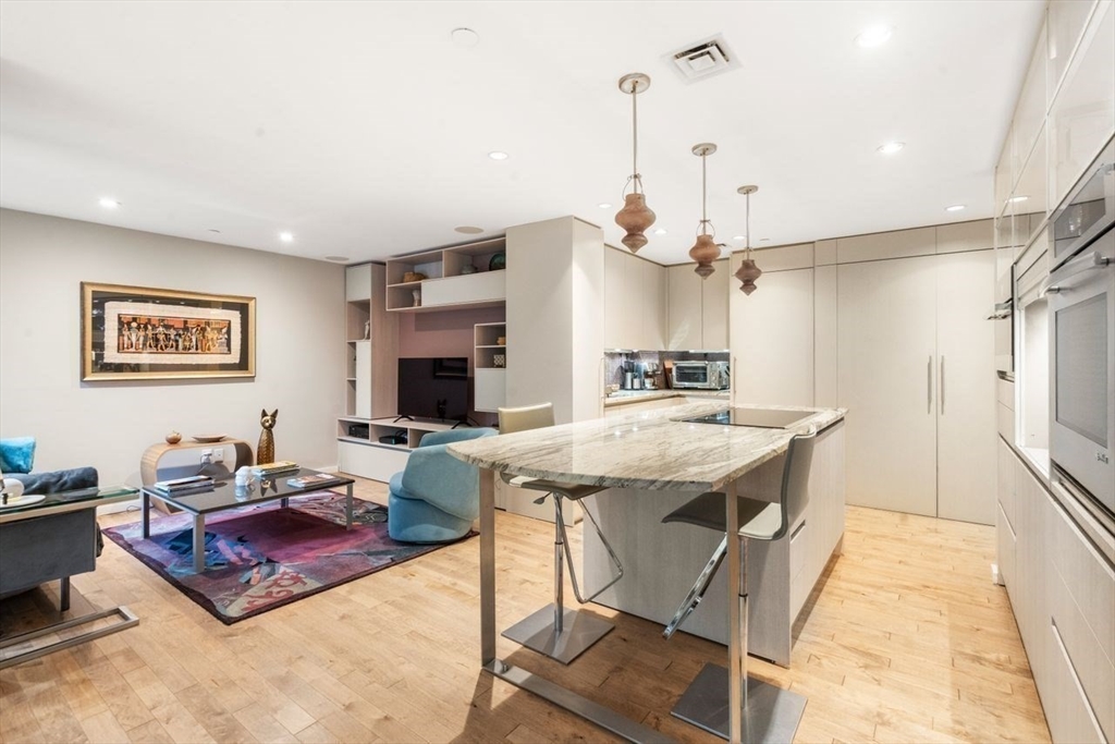 241 Perkins Street, Unit C306 Boston, MA 02130 - Photo 7 of 33 a living room with stainless steel appliances kitchen island granite countertop furniture and a view of kitchen