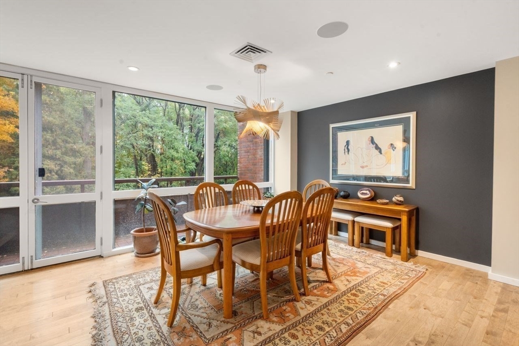 241 Perkins Street, Unit C306 Boston, MA 02130 - Photo 8 of 33 a dining room with furniture a chandelier and wooden floor