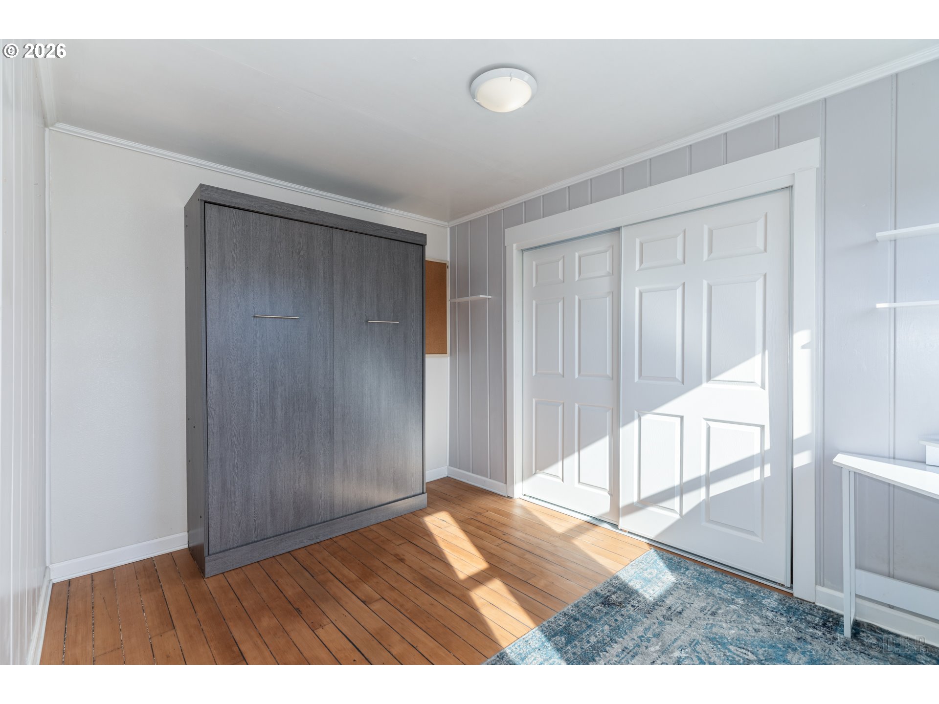 169 North Vernonia Road St. Helens, OR 97051 - Photo 16 of 27 a view of an empty room with wooden floor