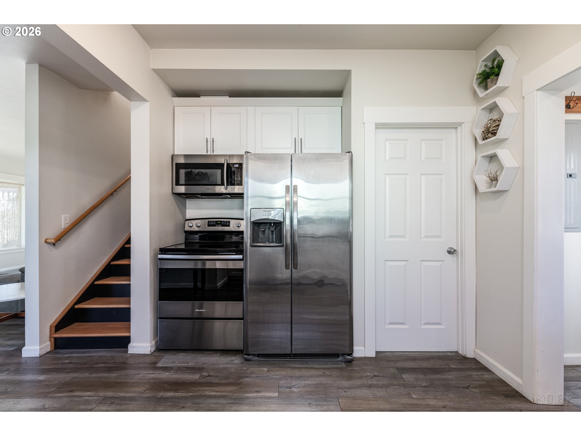 169 North Vernonia Road St. Helens, OR 97051 - Photo 9 of 27 a view of a kitchen with wooden floor electronic appliances and stairs