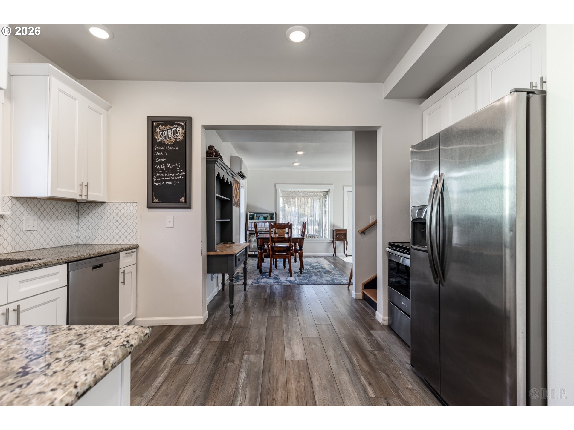 169 North Vernonia Road St. Helens, OR 97051 - Photo 10 of 27 a kitchen with stainless steel appliances granite countertop a refrigerator microwave and wooden floor