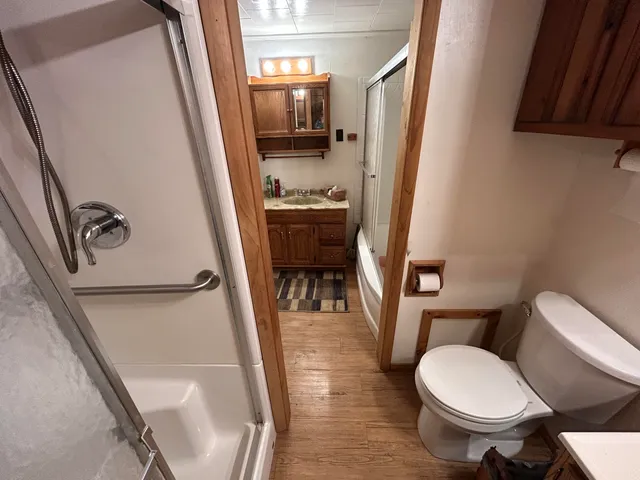 a bathroom with a toilet a sink and a mirror
