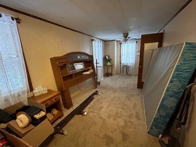 a view of a livingroom with furniture and staircase