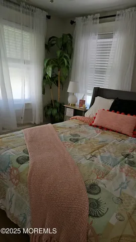 a bedroom with a bed and a potted plant