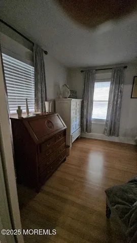 a room with a bed and wooden floor