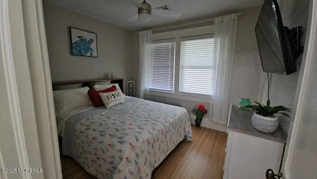 a bed sitting in a bedroom next to a window